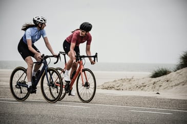 Two women biking